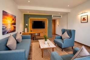 A modern living room with a sofa set, a coffee table, and a flat-screen TV. - BluSalzz Collection Casa Onze Goa (Calangute)