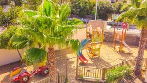 A playground with a slide, swings, and a small car. - Mobile home with AC - Pets OK - 6 guests (Frontignan)
