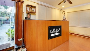 A reception desk with a sign reading "Collection" and "Company Serviced". - Deluxe Skanda Shelters (Bengaluru)