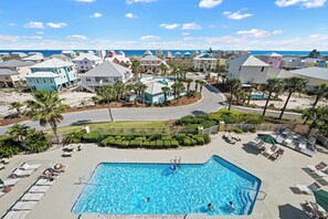 A resort with a swimming pool, palm trees, and beachfront views. - Indies 406 | 1BR/1BA Gulf-View Condo | Sleeps 4 | Balcony & Pool Access (GULF SHORES)