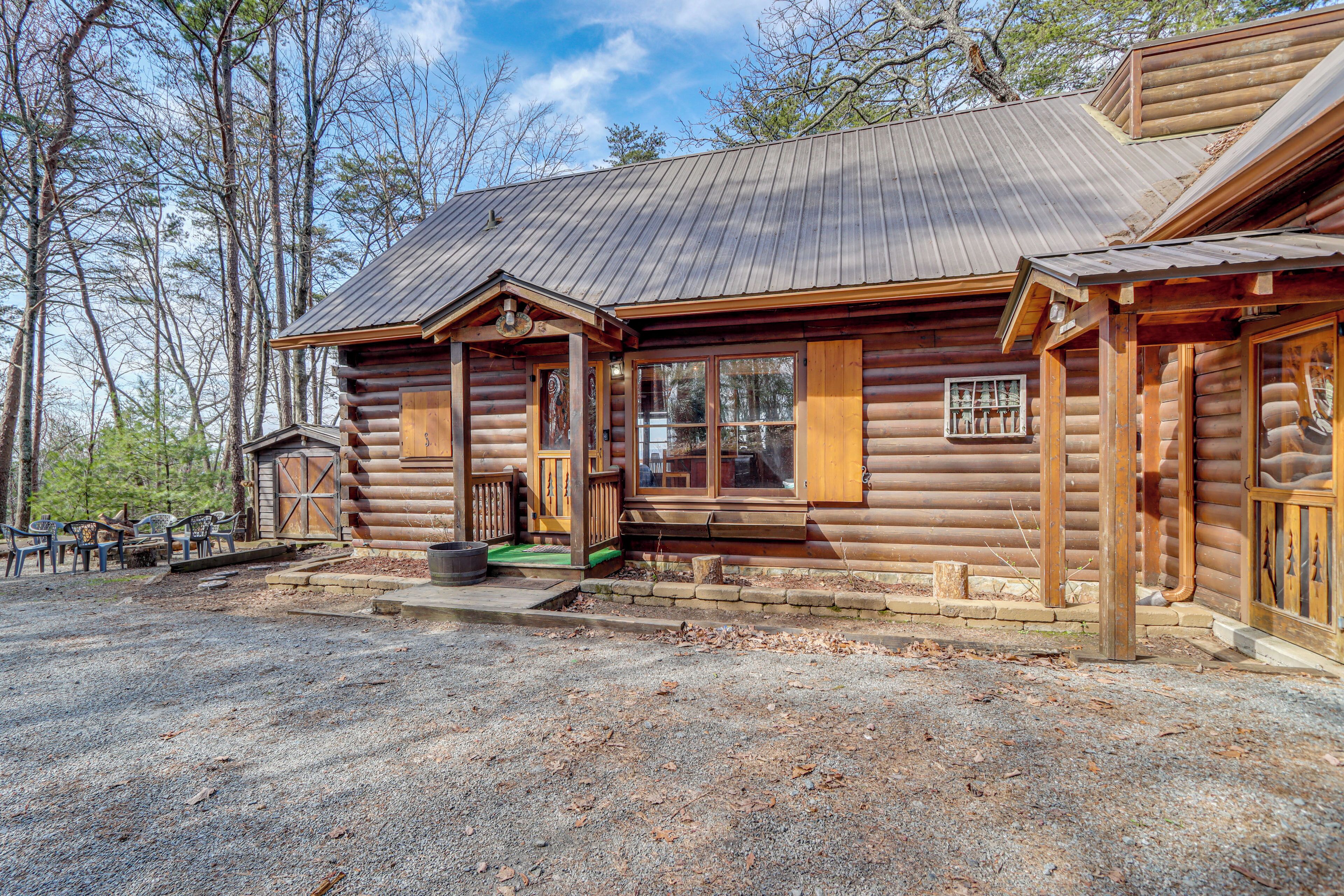 A log cabin with a porch, a window, and a door.