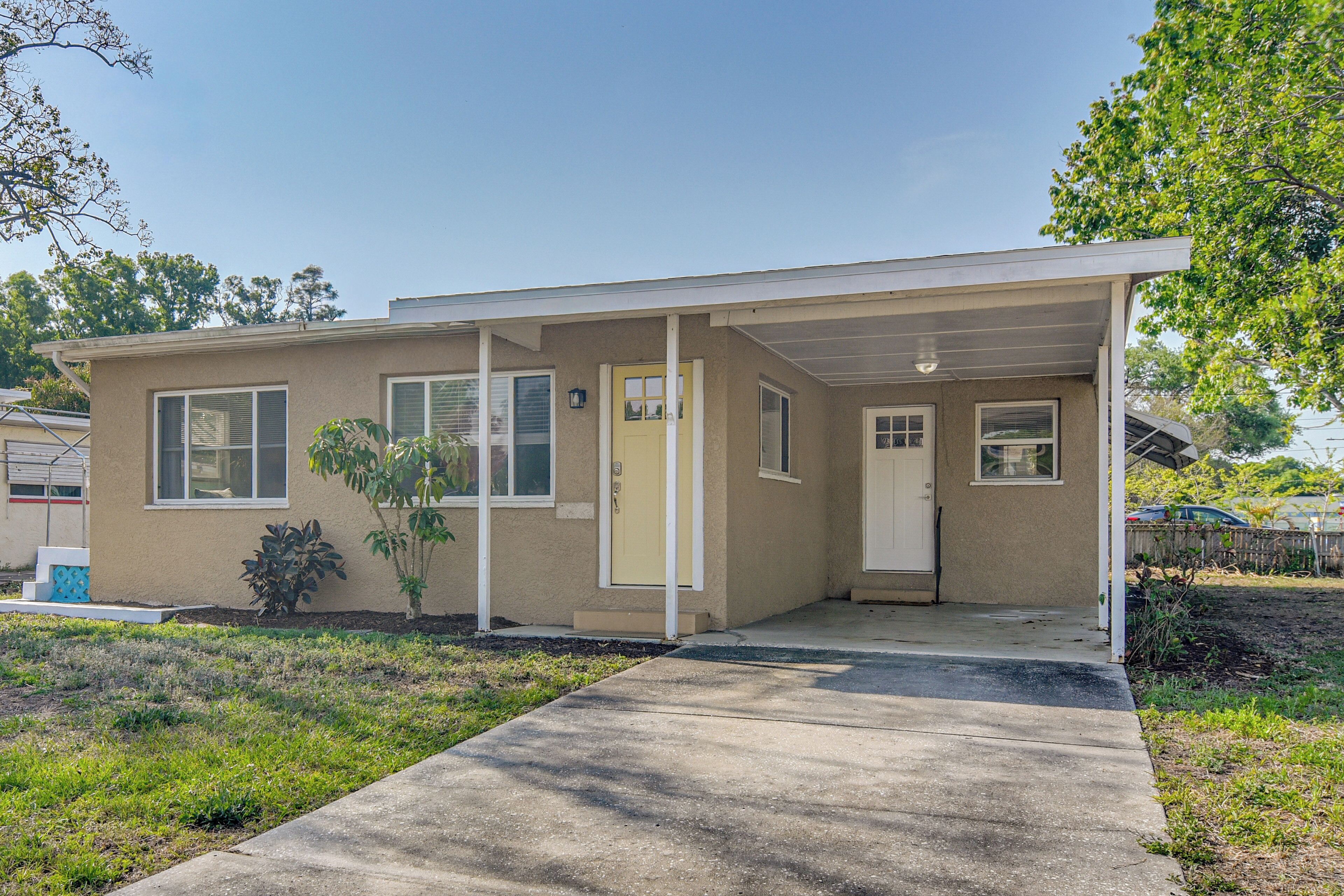 A single-story house with a covered porch, a front door, and a small front yard.