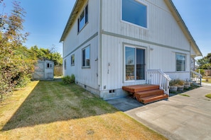A white two-story house with a front porch and a small attached garage. - Seaside Eureka Vacation Rental w/ Bay Views! (Eureka)