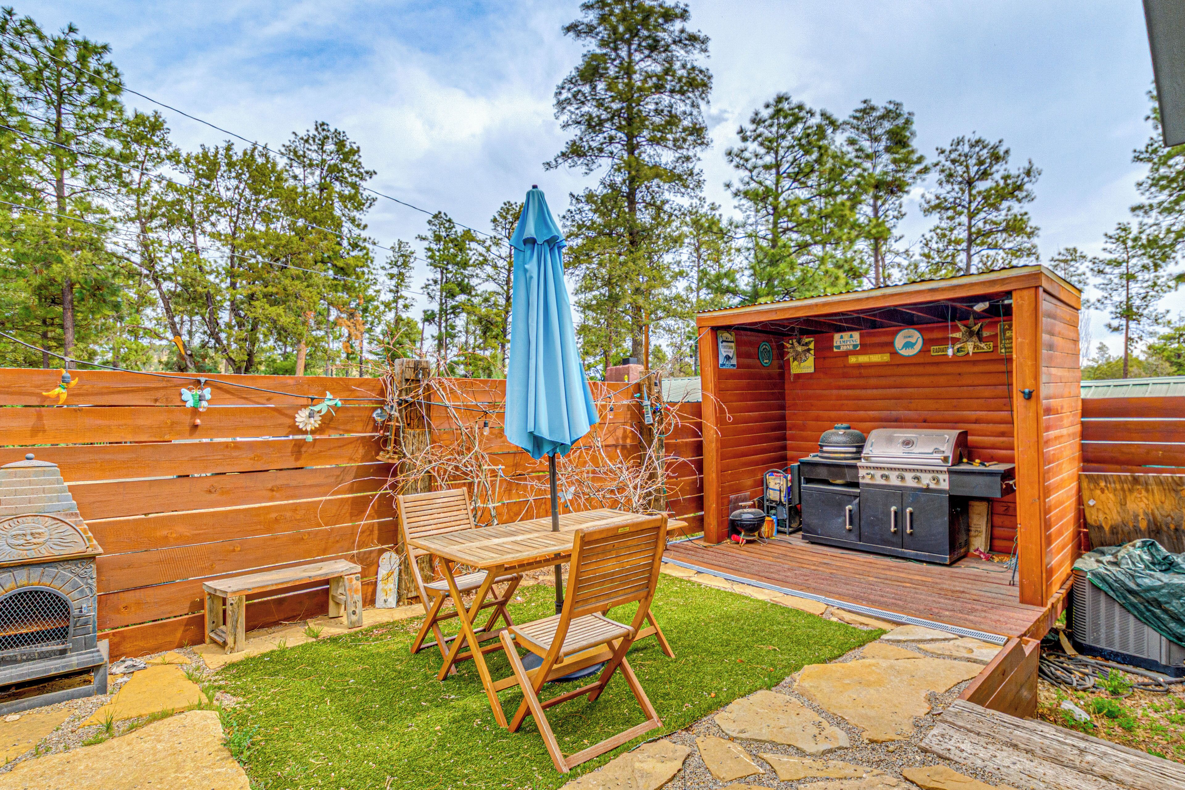 A wooden deck with a grill and outdoor furniture.