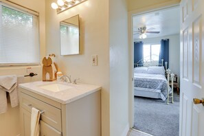 A bathroom with a sink, mirror, and towel rack. - Home Near Reno Industrial Center & Med Centers (Sparks)