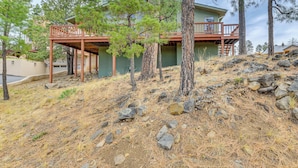 A house with a wooden deck, surrounded by pine trees and rocky terrain. - 1 Mi to Alto Lake! All-season Base w/ Mtn Views (Alto)