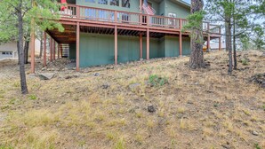 A two-story house with a covered deck and an American flag. - 1 Mi to Alto Lake! All-season Base w/ Mtn Views (Alto)