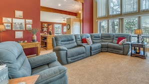 A spacious living room with a sectional sofa, a dining area, and large windows. - 1 Mi to Alto Lake! All-season Base w/ Mtn Views (Alto)