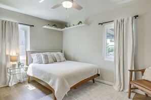 A bedroom with a bed, a nightstand, a chair, a ceiling fan, and a window with curtains. - Quiet Yuma Retreat w/ Hot Tub & Spacious Backyard (Yuma)