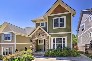 A two-story house with a stone entrance, green siding, and a front porch. - Modern Black Mountain Cottage: 17 Mi to Asheville! (Black Mountain)