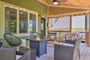 A covered outdoor patio with wicker furniture, a fire feature, and string lights. - Modern Black Mountain Cottage: 17 Mi to Asheville! (Black Mountain)