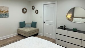 Une chambre à coucher avec un lit, une commode, une porte et des éléments décoratifs sur les murs.