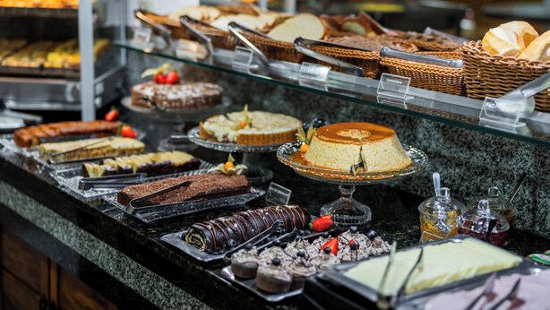 A buffet with various desserts and pastries.