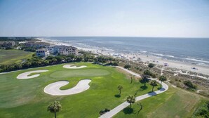 A golf course with sand bunkers, a beach, and ocean views. - 2418 Windsor II - Oceanfront 4-Bed/4-Bath Villa - Fantastic Wrap Around Balcony! (Hilton Head Island)