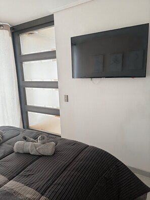 Tabla de planchar con plancha, internet y ropa de cama 
