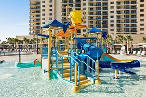 A water park with slides and play structures, surrounded by a pool and lounge chairs. - 112 Arrowhead Unique Lakefront 2br At Kingston 2 Bedroom Condo (Myrtle Beach)