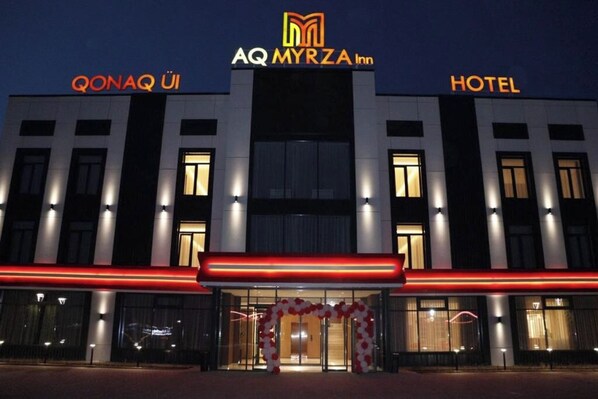 A hotel with a modern facade, large windows, and a prominent entrance.