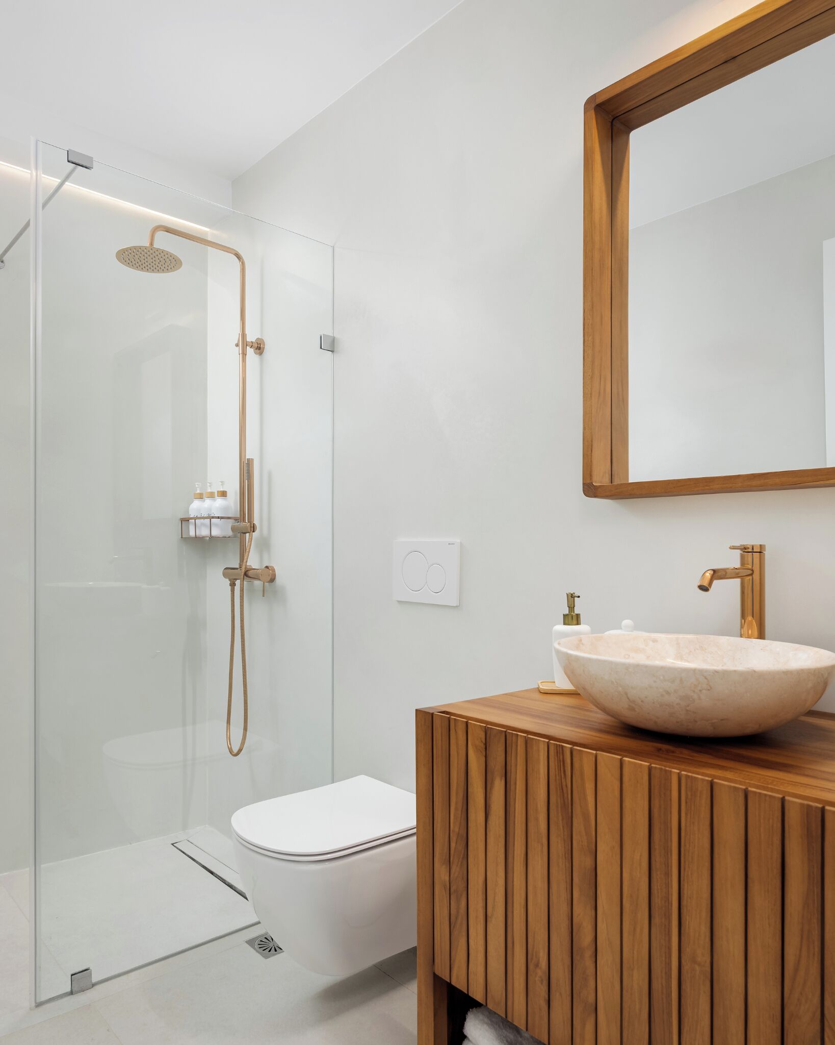 A modern bathroom with a glass shower enclosure, a wooden vanity, and a large mirror.