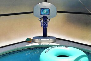 A basketball hoop over a pool with a floating ring. - Spacious 4-bedroom villa in peaceful Kissimmee private pool minutes from Disney (Kissimmee)