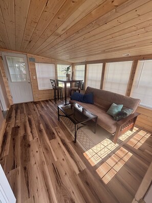 Living area - Log Cabin with a waterfront view. Access to boat ramp and swimming dock! (Afton)