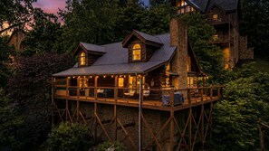 A log cabin with a balcony, surrounded by trees. - Resort Perks|Amazing Location|Hot Tub|Game Room (Pigeon Forge)