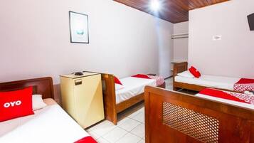 A hotel room with two beds, a wardrobe, a ceiling fan, and a framed picture on the wall.