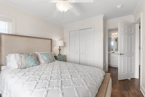 A bedroom with a bed, nightstand, and wardrobe. - Waves on Willis | Hot Tub · Sound Views · 4BR AB (Atlantic Beach)