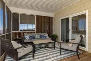 Slide open the king suite door and you`re here: deep cushions, a breeze off the water, and nowhere you need to be. - Waves on Willis | Hot Tub · Sound Views · 4BR AB (Atlantic Beach)