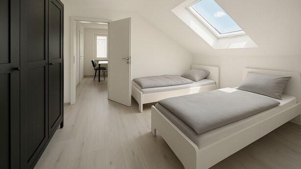 A bedroom with a skylight, two beds, a desk, and a chair. - Fitters' apartment Oberhausen-Rheinhausen, Lönsweg 3, DG (Oberhausen-Rheinhausen)