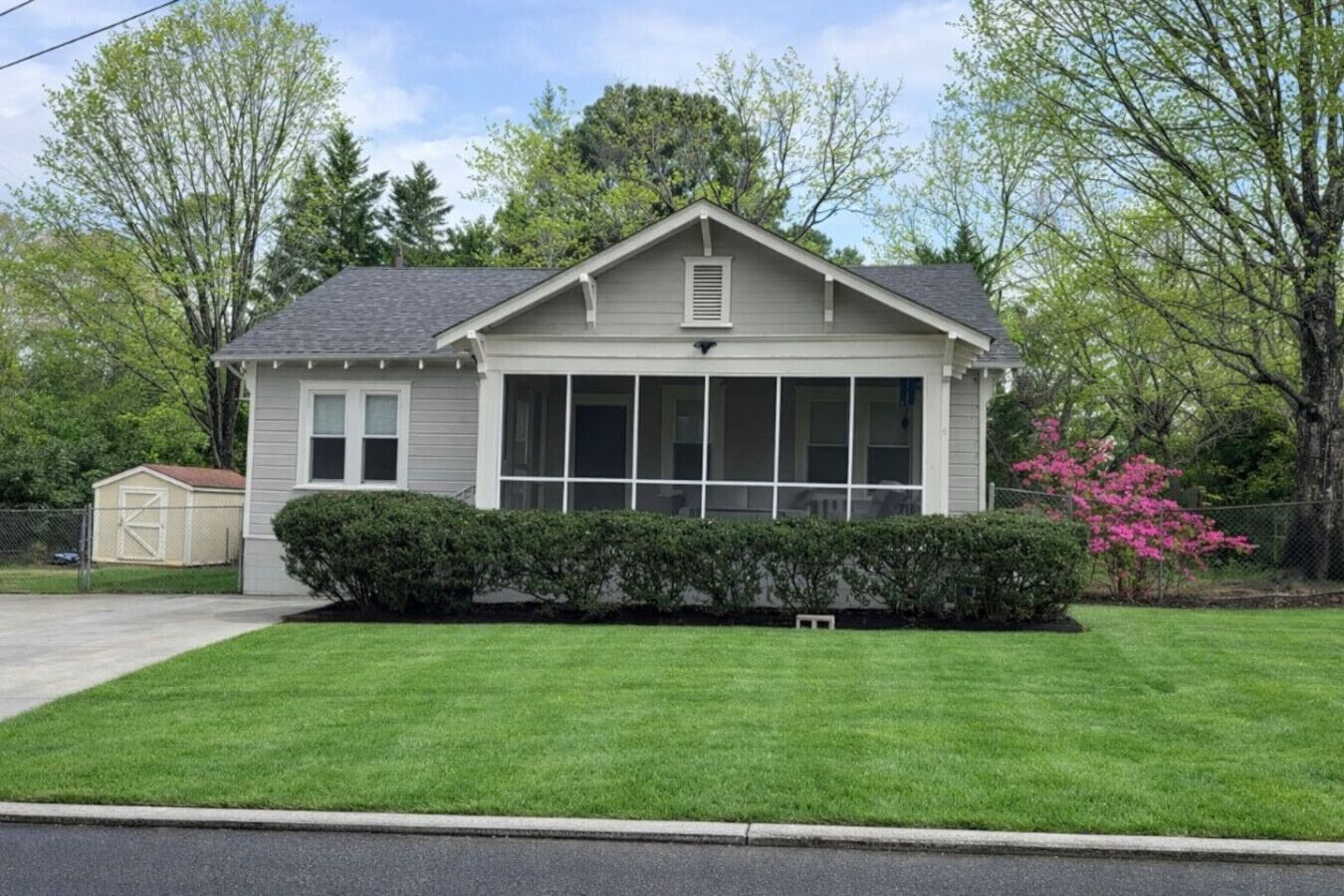 A single-story house with a front porch, a garage, and a well-maintained lawn.