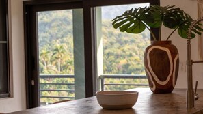 Uma bancada de cozinha com uma tigela e um vaso de madeira com uma planta.