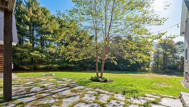 A stone pathway leading to a grassy yard with a tree and a bench. - Falmouth Foreside Cottage Escape - Luxe Kitchen + Walk to the Water! (Falmouth)