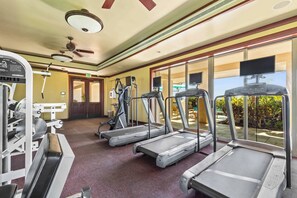 A gym with treadmills, weight machines, and a ceiling fan. - Wai'ula'ula Villa 345 Three Bedroom (Kohala Coast)