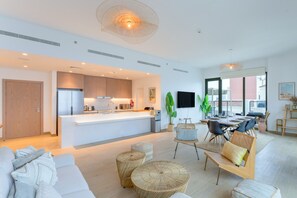 A modern apartment with a kitchen, dining area, and living room. - Le Ciel - 2BR Beachfront with Amazing City and Burj Khalifa View (Port De La Mer)