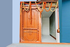 A closed shop with a metal gate and a blue shutter door.