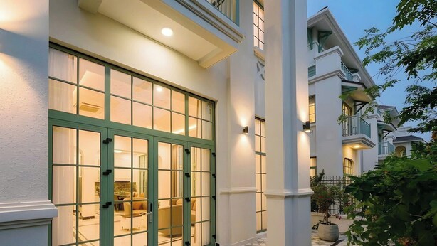 A building with large windows, a well-lit entrance, and a tiled floor.