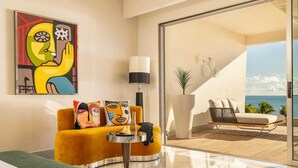 A modern living room with a yellow sofa, a round table, and a large abstract painting. - Luxury Adults-Only Oceanfront Escape in Beautiful Cancun (Cancún)