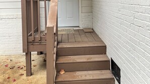 A white brick exterior with a wooden staircase leading to a door. - FIFA FANS STAY HERE! Excellent location minutes from Atlanta Airport and STADIUM (atlanta)