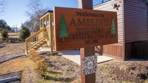A wooden sign with 'Welcome to AMELIA'S HIDDEN HIDEAWAY EST. 2021' and a QR code. - Amelia's Hidden Hideaway/ quiet cottage located in Broussard, La. (Broussard)