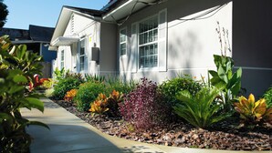 A residential house with a front yard, a sidewalk, and a clear sky. - Adorable 1-bedroom apartment within 5 minute walk to UF Healthand Proton (Jacksonville)