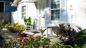 A white house with a porch, a door with a number, and a window with shutters. - Adorable 1-bedroom apartment within 5 minute walk to UF Healthand Proton (Jacksonville)