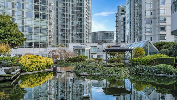 A modern building complex with reflective water features and a gazebo. - Fantastic 1 bed and den in Yaletown across from the world famous Seawall! (Vancouver)