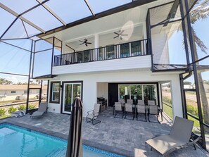 A two-story house with a covered patio, a swimming pool, and a balcony. - THE TOGETHER PLACE 2 (naples)