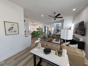 A modern living room with a sofa, coffee table, and decorative items. - THE TOGETHER PLACE 2 (naples)