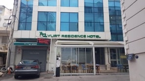 A building with a sign for 'Yurt Residence Hotel' and a visible entrance with a glass door. - Yesilyurt Residence (Izmir)