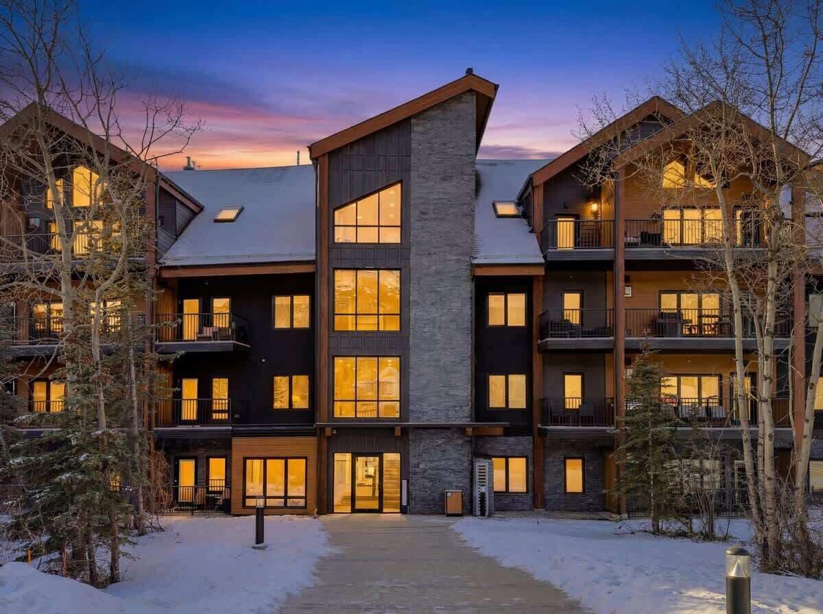 A multi-story hotel with a central atrium, balconies, and a snow-covered ground.