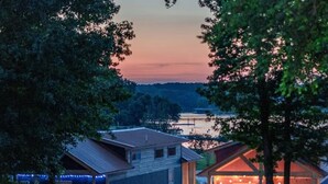 A residential area with houses, a dock, and a sunset sky. - Water's Edge RV Resort (Willis)