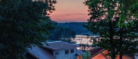 A residential area with houses, a dock, and a sunset sky.