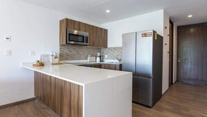 Una cucina moderna con isola centrale, elettrodomestici in acciaio inossidabile e mobili in legno.