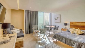 Een hotelkamer met een bed, een bureau, een stoel, een bank en een televisie.